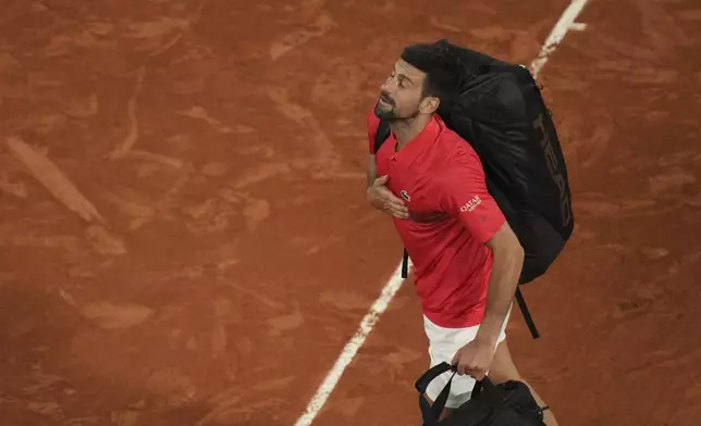Serbia's Novak Djokovic leaves the center court Philippe Chatrier after the semifinal match of the French Tennis Open against Italy's Jannik Sinner at the Roland-Garros stadium in Paris, Friday, June 6, 2025. (AP Photo/Christophe Ena)