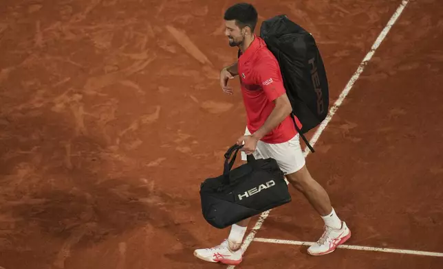 Serbia's Novak Djokovic leaves the center court Philippe Chatrier after the semifinal match of the French Tennis Open against Italy's Jannik Sinner at the Roland-Garros stadium in Paris, Friday, June 6, 2025. (AP Photo/Christophe Ena)
