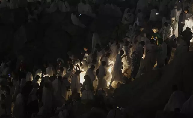 Muslim pilgrims arrive at the rocky hill known as the Mountain of Mercy on the Plain of Arafat during the annual Hajj pilgrimage near the holy city of Mecca, Saudi Arabia, Thursday, June 5, 2025. (AP Photo/Amr Nabil)
