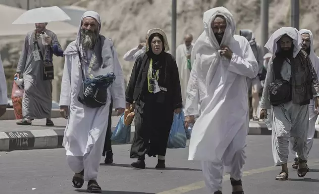 Muslim pilgrims prepare to enter the Grand Mosque, during the annual Hajj pilgrimage in Mecca, Saudi Arabia, Monday, June 2, 2025. (AP Photo/Amr Nabil)