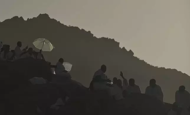 Muslim pilgrims gather a top of the rocky hill known as the Mountain of Mercy, on the Plain of Arafat, during the annual Hajj pilgrimage near the holy city of Mecca, Saudi Arabia, Thursday, June 5, 2025. (AP Photo/Amr Nabil)