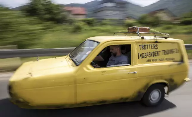 Tarik Fatic along with his brother Mirnes drives the Reliant Regal, an exact copy of the famous BBC TV show "Only Fools and Horses" iconic yellow car in Sarajevo, Bosnia, Wednesday, June 4, 2025. (AP Photo/Armin Durgut)