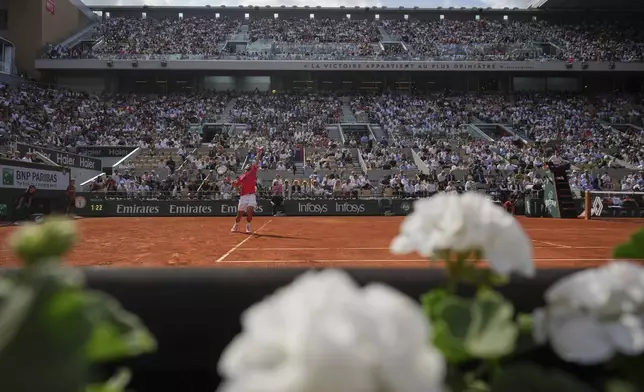 Serbia's Novak Djokovic serves against Britain's Cameron Norrie during their fourth round match of the French Tennis Open at the Roland-Garros stadium in Paris, Monday, June 2, 2025. (AP Photo/Thibault Camus)
