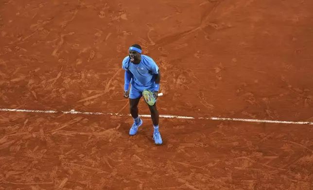 Frances Tiafoe of the U.S. celebrates beating Germany's Daniel Altmaier during their fourth round match of the French Tennis Open, at the Roland-Garros stadium, in Paris, Sunday, June 1 2025. (AP Photo/Lindsey Wasson)