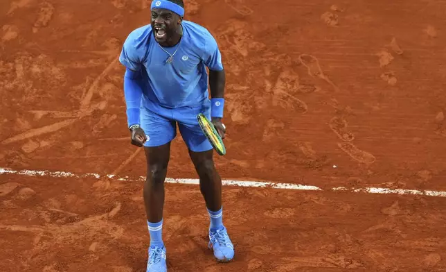 Frances Tiafoe of the U.S. celebrates beating Germany's Daniel Altmaier during their fourth round match of the French Tennis Open, at the Roland-Garros stadium, in Paris, Sunday, June 1 2025. (AP Photo/Lindsey Wasson)