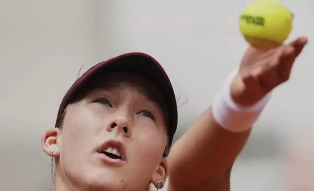 Russia's Mirra Andreeva serves against Australia's Daria Kasatkina during their fourth round match of the French Tennis Open at the Roland-Garros stadium in Paris, Monday, June 2, 2025. (AP Photo/Christophe Ena)