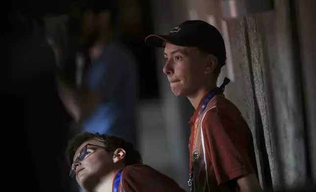 Ball boys follow the fourth round match of the French Tennis Open between Russia's Mirra Andreeva and Australia's Daria Kasatkina at the Roland-Garros stadium in Paris, Monday, June 2, 2025. (AP Photo/Christophe Ena)
