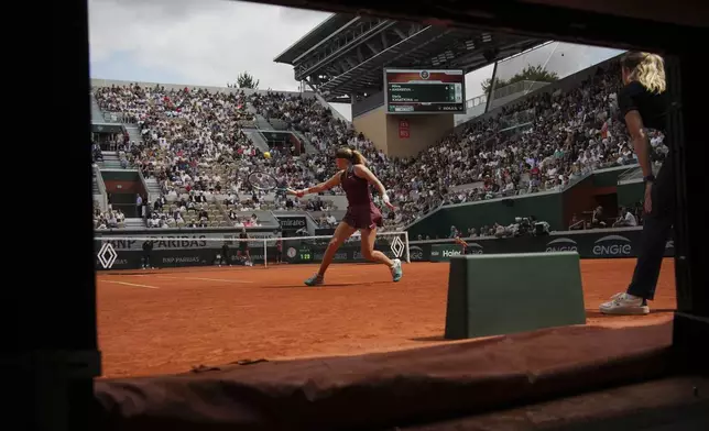 Russia's Mirra Andreeva plays a shot against Australia's Daria Kasatkina during their fourth round match of the French Tennis Open at the Roland-Garros stadium in Paris, Monday, June 2, 2025. (AP Photo/Christophe Ena)
