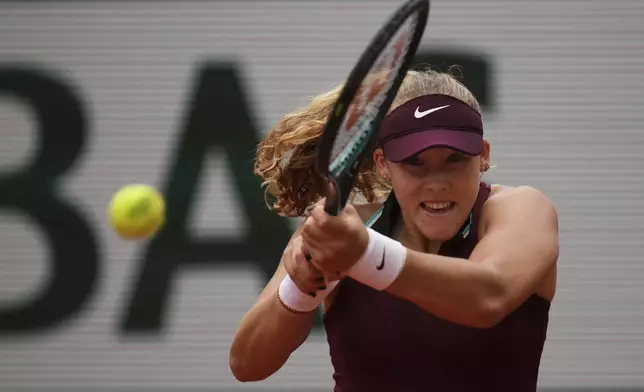 Russia's Mirra Andreeva plays a shot against Australia's Daria Kasatkina during their fourth round match of the French Tennis Open at the Roland-Garros stadium in Paris, Monday, June 2, 2025. (AP Photo/Christophe Ena)