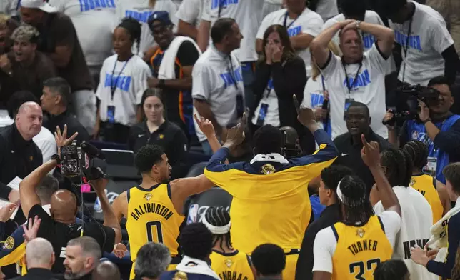 Indiana Pacers guard Tyrese Haliburton (0) and teammates celebrate as they leave the court after winning Game 1 of the NBA Finals basketball series against the Oklahoma City Thunder Thursday, June 5, 2025, in Oklahoma City. (AP Photo/Nate Billings)