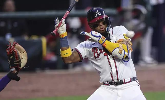 Atlanta Braves' Ronald Acuña Jr. tries to avoid a pitch in the first inning of a baseball game against the Arizona Diamondbacks, Wednesday, June 4, 2025, in Atlanta. (AP Photo/Colin Hubbard)