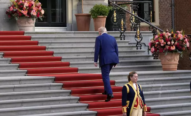 President Donald Trump climbs the stairs to the Paleis Huis ten Bosch ahead of the NATO summit in The Hague, Netherlands, Tuesday, June 24, 2025. (AP Photo/Alex Brandon)