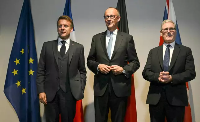 From left, France's President Emmanuel Macron, Germany's Chancellor Friedrich Merz and Britain's Prime Minister Keir Starmer pose as they meet on the sidelines of the two-day NATO's Heads of State and Government summit in The Hague, Tuesday, June 24, 2025. (Ben Stansall/Pool Photo via AP)