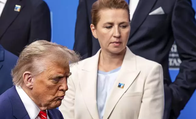 President Donald Trump, left, walks by Denmark's Prime Minister Mette Frederiksen prior to a group photo of NATO heads of state and government at the NATO summit in The Hague, Netherlands, Wednesday, June 25, 2025. (AP Photo/Geert Vanden Wijngaert)