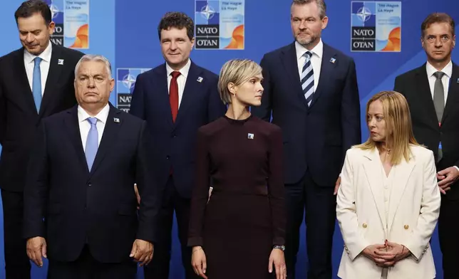 Front row left to right, Hungary's Prime Minister Viktor Orban, Iceland's Prime Minister Kristrun Frostadottir and Italy's Prime Minister Giorgia Meloni pose during a group photo of NATO heads of state and government at the NATO summit in The Hague, Netherlands, Wednesday, June 25, 2025. (AP Photo/Geert Vanden Wijngaert)