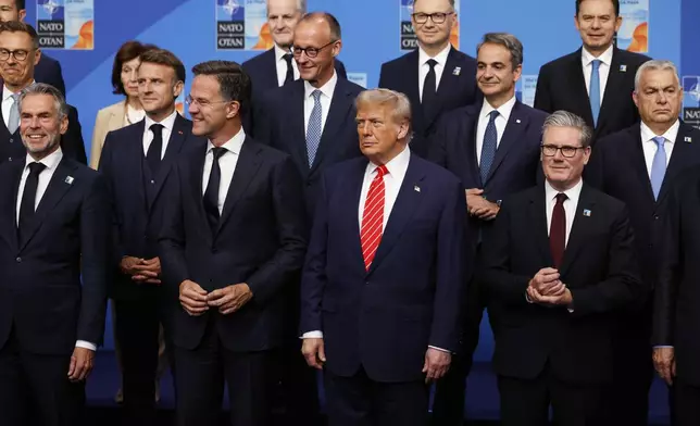 President Donald Trump, center front, poses during a group photo of NATO heads of state and government at the NATO summit in The Hague, Netherlands, Wednesday, June 25, 2025. (AP Photo/Geert Vanden Wijngaert)