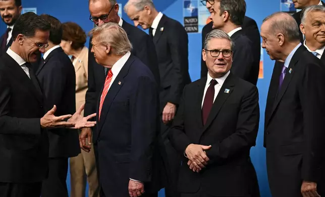 NATO Secretary General Mark Rutte, from left, President Donald Trump, Britain's Prime Minister Keir Starmer and Turkey's President Recep Tayyip Erdogan gather with NATO country leaders for a family photo during the NATO summit in The Hague, Netherlands, Wednesday, June 25, 2025. (Ben Stansall/Pool Photo via AP)