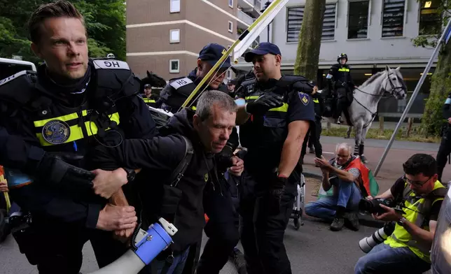 Police detain a protester during a rally against the NATO summit in The Hague, Netherlands, Wednesday, June 25, 2025. (AP Photo/Patrick Post)