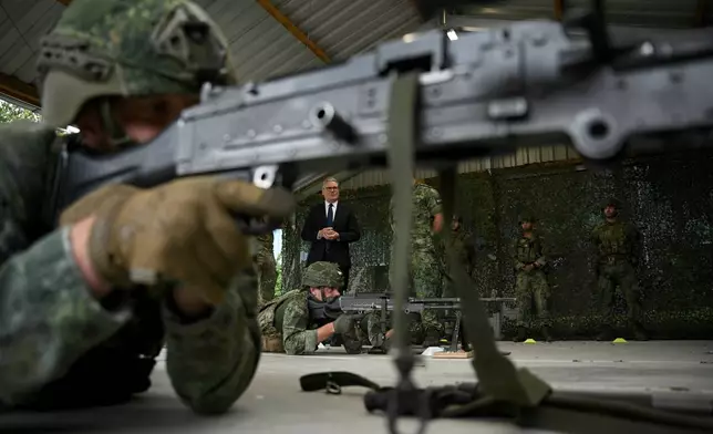 Britain's Prime Minister Keir Starmer, center, visits the Netherlands marines training base, as part of the UK-Netherlands Joint Amphibious Force in Rotterdam, Netherlands, Tuesday, June 24, 2025, on the sidelines of the NATO summit. (Ben Stansall/Pool via AP)