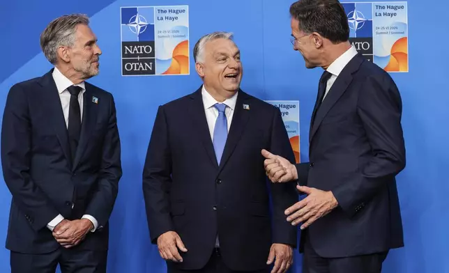 Hungary's Prime Minister Viktor Orban is greeted by NATO Secretary General Mark Rutte, right, and Netherland's Prime Minister Dick Schoof, left, at an official welcome during the NATO summit in The Hague, Netherlands, Wednesday, June 25, 2025. (AP Photo/Geert Vanden Wijngaert)