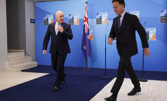 NATO Secretary General Mark Rutte, right, walks with New Zealand's Prime Minister Christopher Luxon ahead of the NATO summit in The Hague, Netherlands, Tuesday, June 24, 2025. (AP Photo/Geert Vanden Wijngaert, Pool)