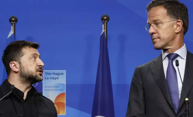 Ukraine's President Volodymyr Zelenskyy, left, speaks with NATO Secretary General Mark Rutte prior to a meeting on the sidelines of the NATO summit in The Hague, Netherlands, Tuesday, June 24, 2025. (AP Photo/Geert Vanden Wijngaert)