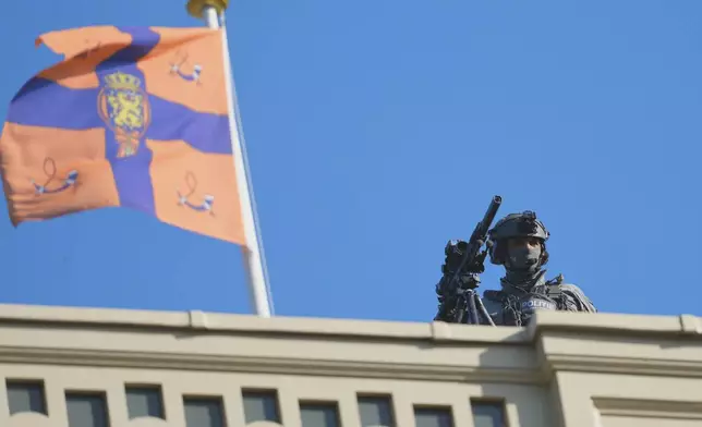 A police sharpshooter monitors the area ahead of a formal dinner at the Paleis Huis ten Bosch ahead of the NATO summit in The Hague, Netherlands, Tuesday, June 24, 2025. (AP Photo/Markus Schreiber)