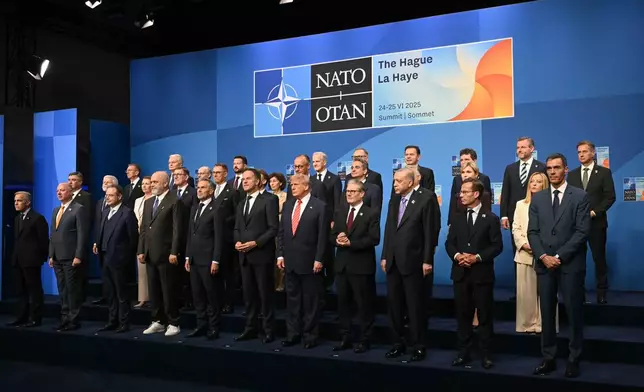 Netherlands' Prime Minister Dick Schoof, front row from fifth left, NATO Secretary General Mark Rutte, US President Donald Trump, Britain's Prime Minister Keir Starmer and Turkey's President Recep Tayyip Erdogan pose with NATO country leaders for a family photo during the NATO summit in The Hague, Netherlands, Wednesday, June 25, 2025. (Ben Stansall/Pool Photo via AP)