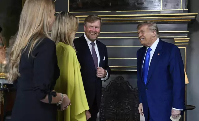 President Donald Trump, right, is welcomed by Netherland's King Willem Alexander, Netherland's Queen Maxima and Netherland's Crown Princess Amalia as he arrives for a formal dinner at the Paleis Huis ten Bosch ahead of the NATO summit in The Hague, Netherlands, Tuesday, June 24, 2025. (Misha Schoemakers, Pool Photo via AP)
