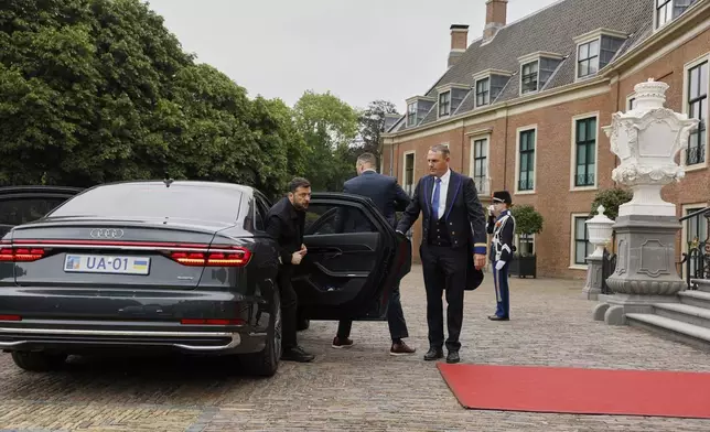 Ukraine's President Volodymyr Zelenskyy, left, arrives at the Paleis Huis ten Bosch ahead of a dinner on the sidelines of the NATO summit in The Hague, Netherlands, Tuesday, June 24, 2025. (Remko de Waal, Pool Photo via AP)