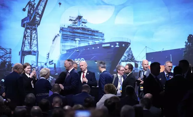 European Commission President Ursula von der Leyen, third left, and Britain's Defense Secretary John Healey, center, arrive for the NATO defense forum on the sidelines of the NATO summit in The Hague, Netherlands, Tuesday, June 24, 2025. (AP Photo/Matthias Schrader)