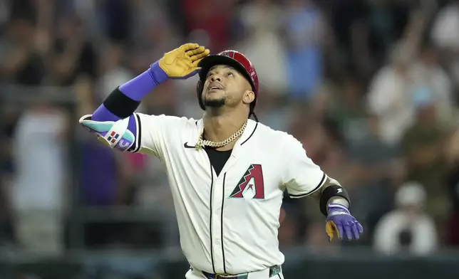 Arizona Diamondbacks' Ketel Marte looks up as he rounds the bases after hitting a three-run home run against the Miami Marlins during the fourth inning of a baseball game Saturday, June 28, 2025, in Phoenix. (AP Photo/Ross D. Franklin)