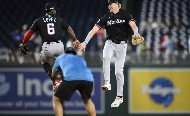Miami Marlins' Otto Lopez (6) and Kyle Stowers, right, celebrate after a baseball game against the Washington Nationals, early Saturday, June 14, 2025, in Washington. (AP Photo/Nick Wass)