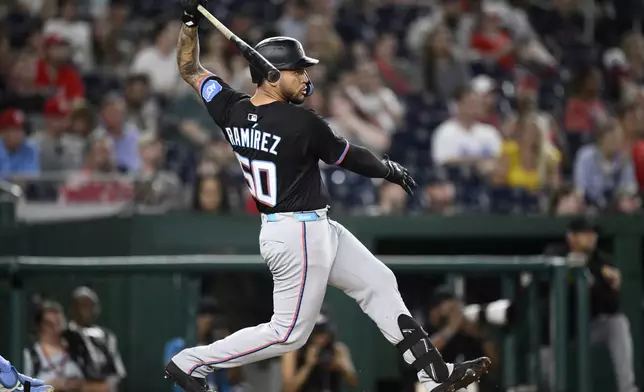 Miami Marlins' Agustin Ramirez follows through on his single during the eighth inning of a baseball game against the Washington Nationals, Friday, June 13, 2025, in Washington. (AP Photo/Nick Wass)