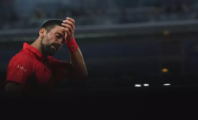 Serbia's Novak Djokovic wipes his face during a third-round match against Austria's Filip Misolic in the French Tennis Open at the Roland-Garros stadium in Paris, Saturday, May 31, 2025. (AP Photo/Lindsey Wasson)