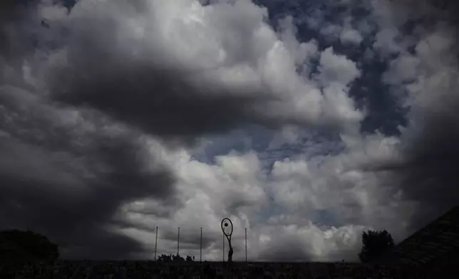 Australia's Daria Kasatkina is silhouetted as she plays Spain's Paula Badosa during their third round match of the French Tennis Open, at the Roland-Garros stadium, in Paris, Saturday, May 31, 2025. (AP Photo/Christophe Ena)