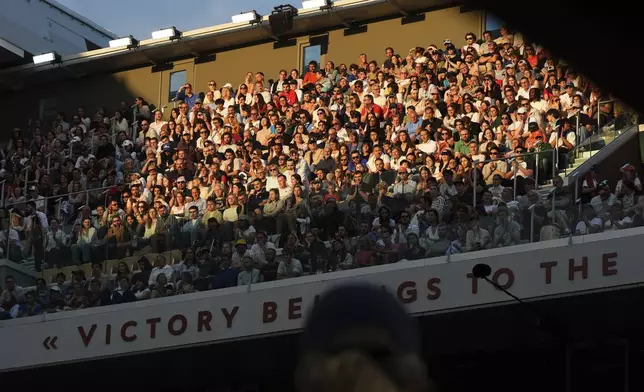 The evening sun hits the stands during a second-round match between Britain's Jack Draper and France's Gael Monfils in the French Tennis Open at the Roland-Garros stadium in Paris, Thursday, May 29, 2025. (AP Photo/Lindsey Wasson)