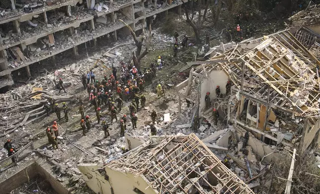 Firefighters, rescue workers and military work at the site of a direct missile strike launched from Iran in Tel Aviv, Israel, on Sunday, June 22, 2025. (AP Photo/Oded Balilty)