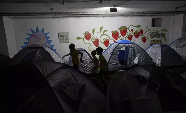 Children play in a public bomb shelter in Tel Aviv, Israel, on Saturday, June 21, 2025, amid concerns over potential Iranian missile attacks. (AP Photo/Oded Balilty)