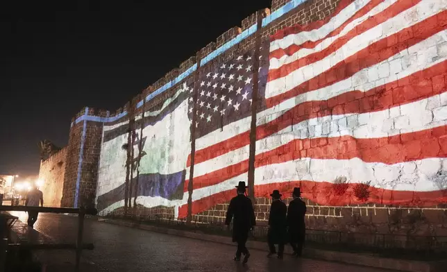 An Image of the U.S. and Israeli flags is projected on the walls of Jerusalem's Old City, Sunday, July 22, 2025. Following the U.S. involvement in the war between Israel and Iran. (AP Photo/Mahmoud Illean)
