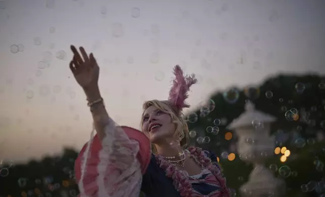 Alexandra of Ukraine poses in the gardens of the Versailles castle before the Great Masked Ball in Versailles, outside Paris, Saturday, June 21, 2025. (AP Photo/Christophe Ena)