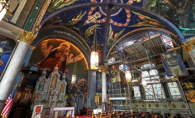 A 32-foot-high scaffold allows art conservation workers close up access to murals by Maxo Vanka on the ceiling in St. Nicholas Croatian Catholic Church as part of an ongoing preservation project in Millvale, Pa., Tuesday, March 18, 2025. (AP Photo/Gene J. Puskar)