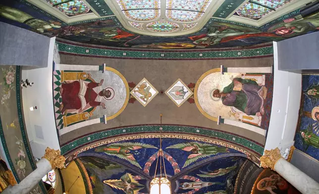 After removal of a 32-foot-high scaffold, murals by Max Vanka depicting St. Mark, left, and St. Matthew, right, are revealed in St. Nicholas Croatian Catholic Church after undergoing preservation efforts in Millvale, Pa., Wednesday, May 28, 2025. (AP Photo/Gene J. Puskar)