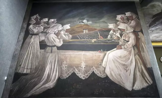 A mural by Croatian-American artist Maxo Vanka titled "Croatian Mother Raises Her Son for War" is displayed inside St. Nicholas Croatian Catholic Church in Millvale, Pa., Tuesday, March 18, 2025. (AP Photo/Gene J. Puskar)