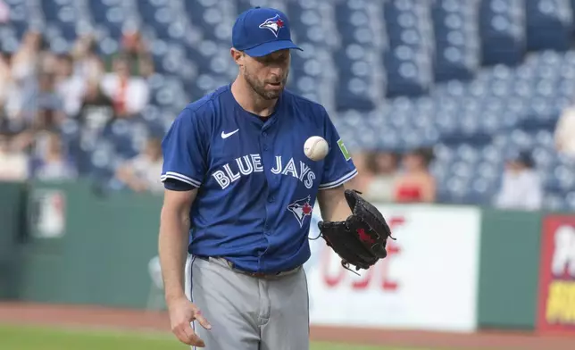 Toronto Blue Jays starting pitcher Max Scherzer pauses between pitches against the Cleveland Guardians during the first inning of a baseball game, Wednesday, June 25, 2025, in Cleveland. (AP Photo/Phil Long)