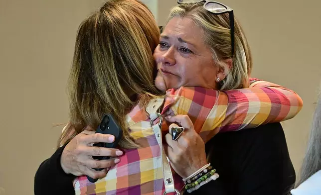 Lesli Colin Johnsen, right, hugs Beth Blacker before a community vigil at the Boulder Jewish Community Center, Wednesday, June 4, 2025, in Boulder, Colo. (Andy Cross/The Denver Post via AP, Pool)