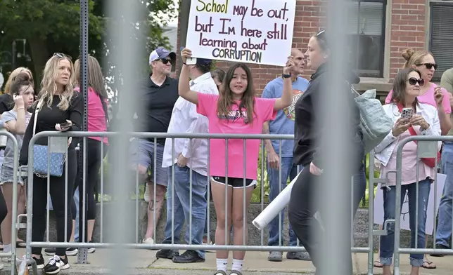 Makena Smirles, 12, of Auburn, ME, center, stands with fellow Karen Read, supporters , outside the Dedham, Mass. courthouse, on the day of closing arguments of Read's trial at Norfolk Superior Court, Friday, June 13, 2025, in Dedham, Mass. (AP Photo/Josh Reynolds)