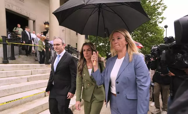Karen Read, center, leaves Norfolk Superior Court for the day following jury deliberations at her trial, Tuesday, June 17, 2025, in Dedham, Mass. (AP Photo/Charles Krupa)