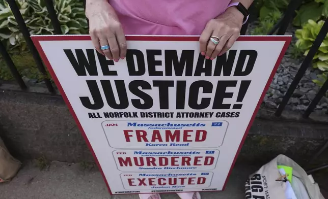 A supporter of Karen Read holds a sign prior to the day's session outside Norfolk Superior Court, Thursday, June 12, 2025, in Dedham, Mass. (AP Photo/Charles Krupa)