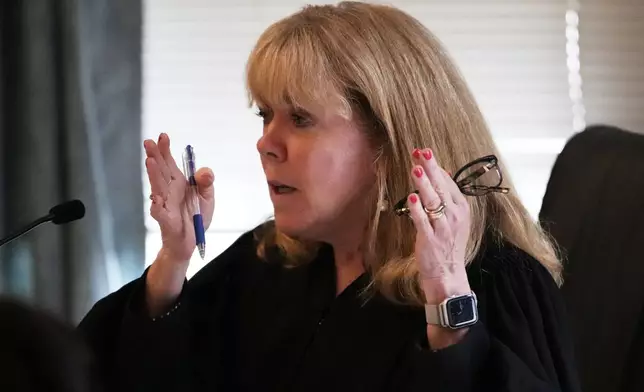 Judge Beverly Cannone talks with defense attorney Robert Alessi during the Karen Read trial at Norfolk Superior Court, Thursday, June 12, 2025, in Dedham, Mass. (AP Photo/Charles Krupa, Pool)